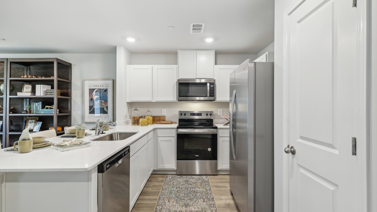 Kitchen peninsula with white countertops.