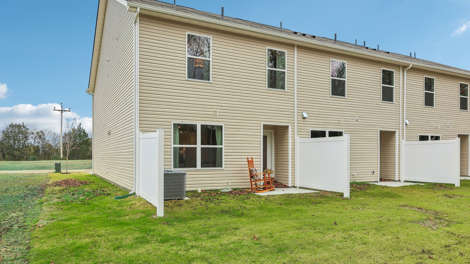 Exterior rear of house with concrete slab.
