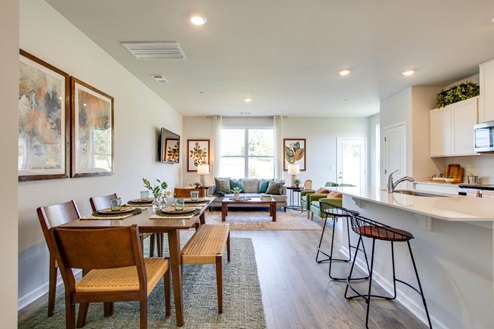Open living room with windows and modern island kitchen