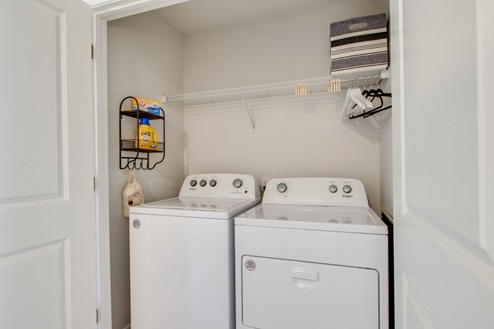Laundry room upstairs in open concept floorplan townhome