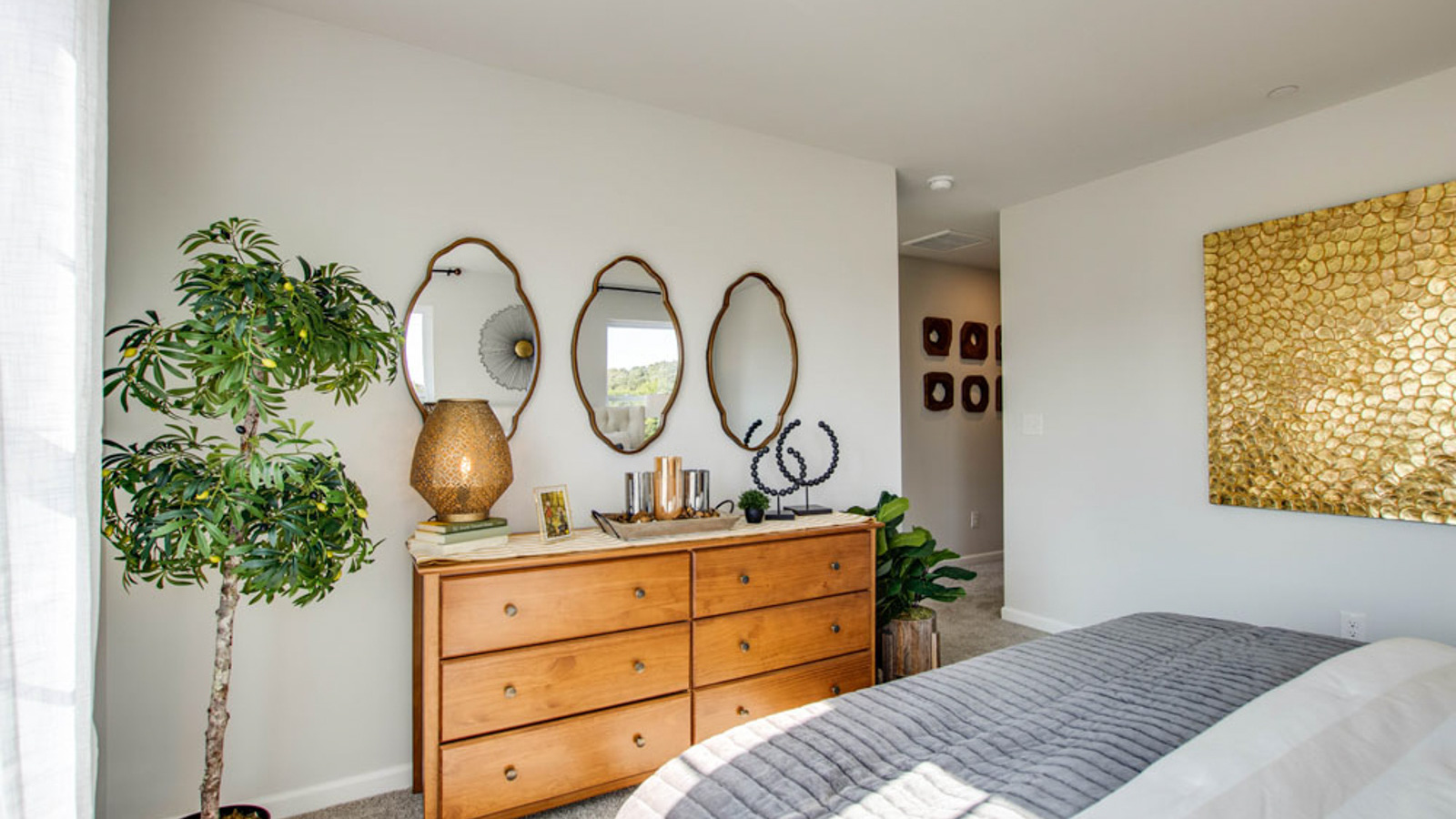 Primary bedroom features ample space, double windows, soft carpet, a stylish walk-in closet, and a private ensuite bath