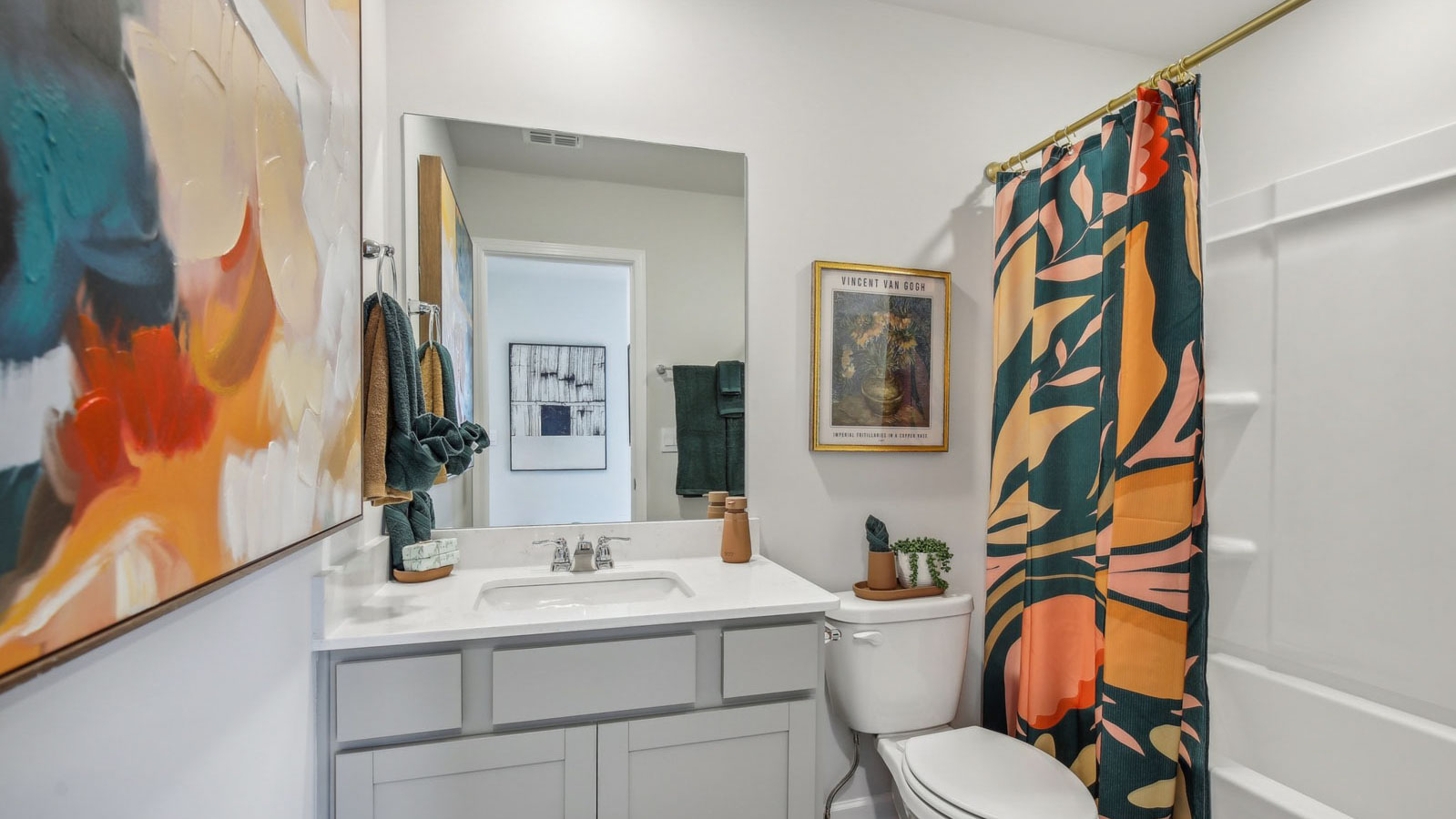 Family bathroom with stylish vanity, mirror, polished fixtures, cabinets, tub-shower combo in King's Landing
