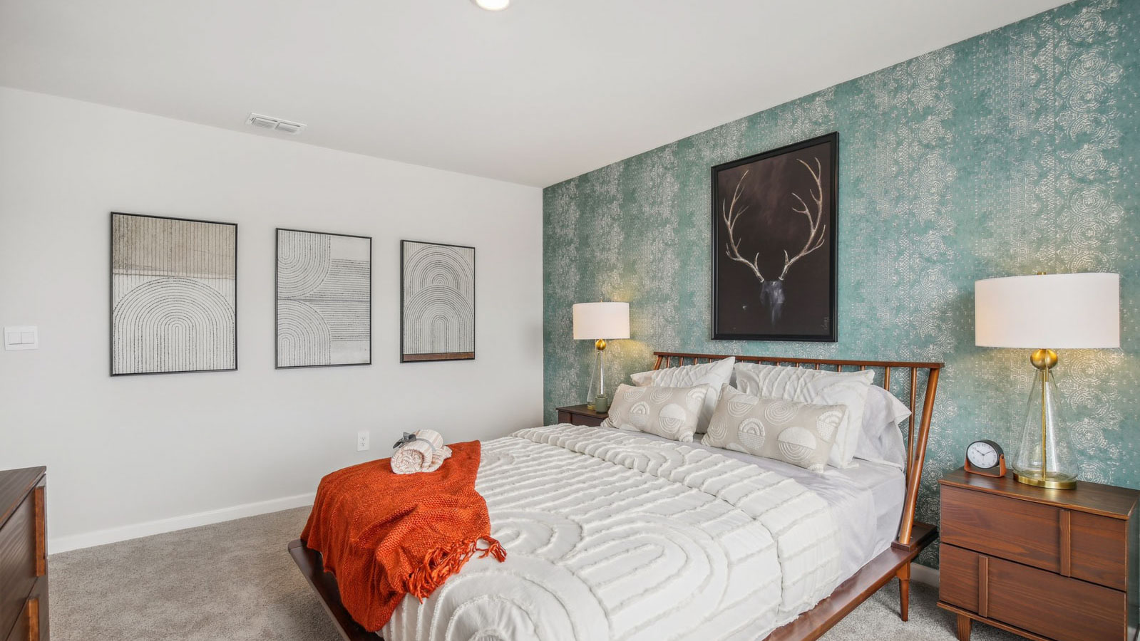 Primary bedroom in this townhome features ample space, double windows, soft carpet, walk-in closet, and a private ensuite bath