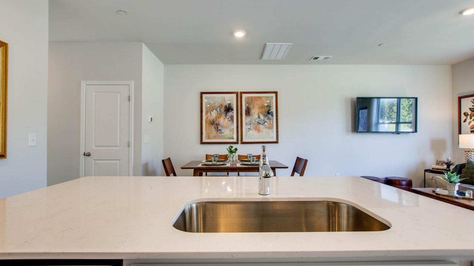 Central kitchen island adds a sink, seating, designed to anchor the home, pantry, prep zones, perfect for entertaining, everyday life
