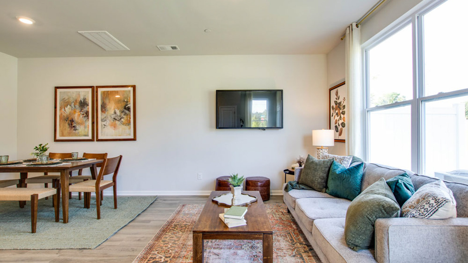 Main front level living room adds a bright space with windows, open concept connections to kitchen, living spaces, foyer