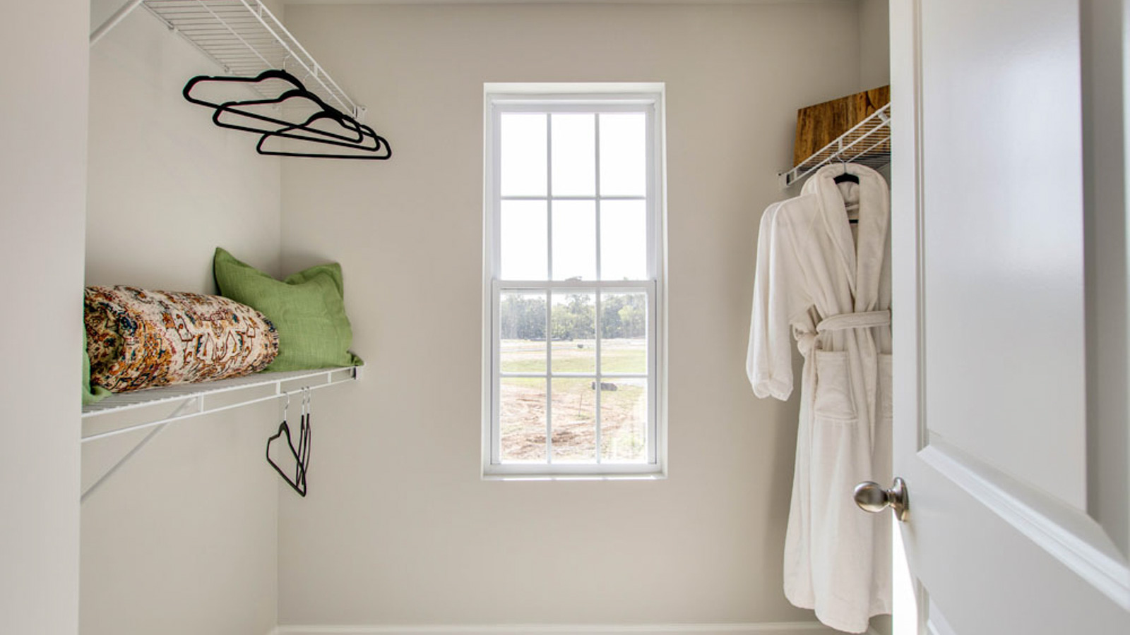 Primary walk-in wardrobe in our new build townhome adds stylish storage and built-in space