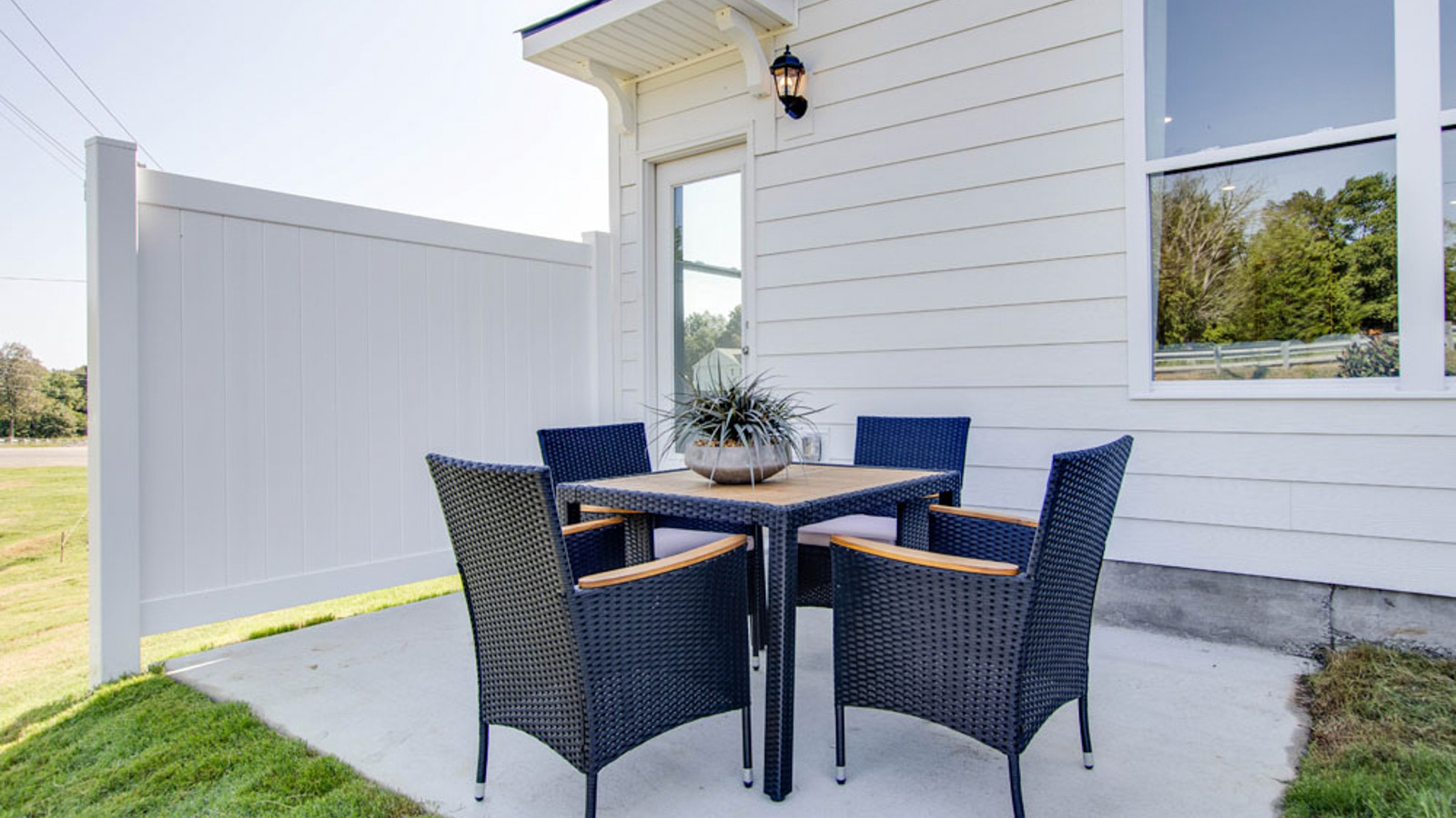 Outside with concrete patio area offering room for seating, grill setup, and a transition from indoor to outdoor living