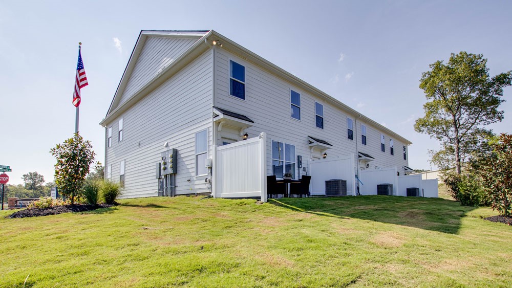 New townhomes by D.R. Horton backyards featuring paved patio for outdoor entertaining, ideal for gatherings