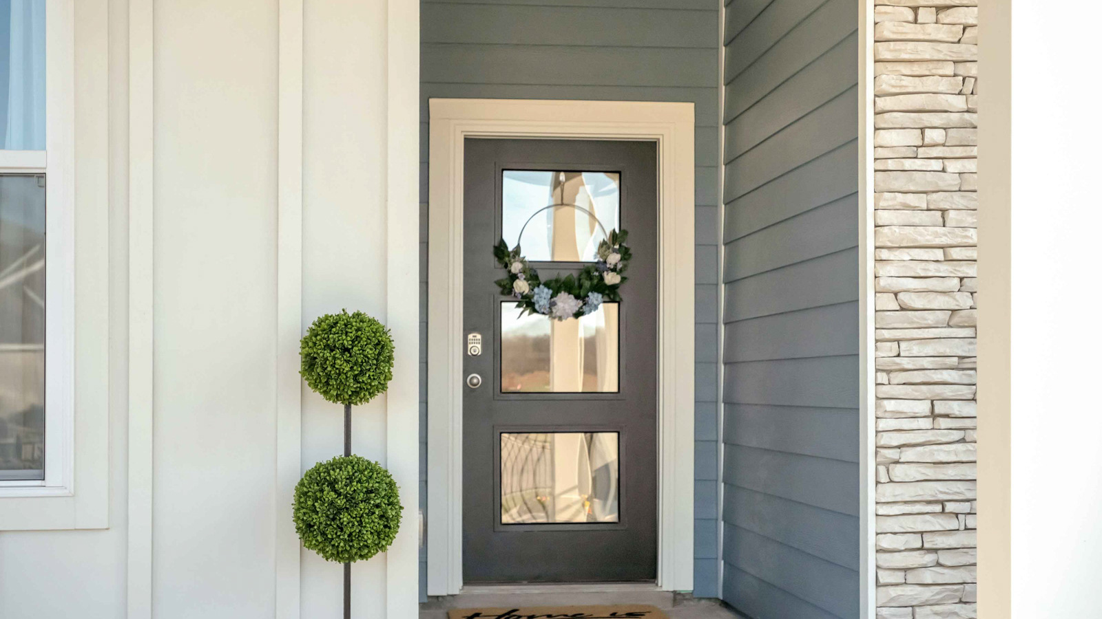 Front Covered Door and porch-new residence, bring you home to this well-crafted and designed home