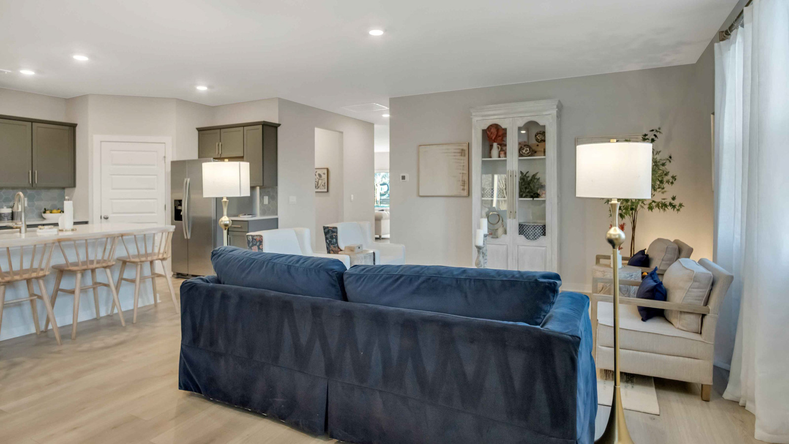 View from living room into dining room, connected to the kitchen, outdoor backyard access at Preserve at Medina