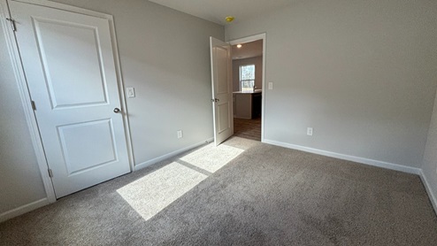 Bedroom in modern, open concept new home