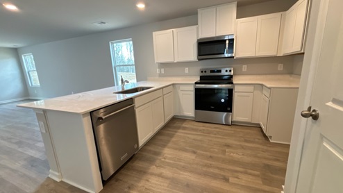 Modern kitchen with quartz countertops and stainless steel appliances