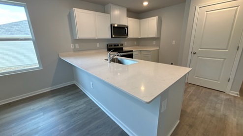 Modern kitchen with quartz countertops and stainless steel appliances