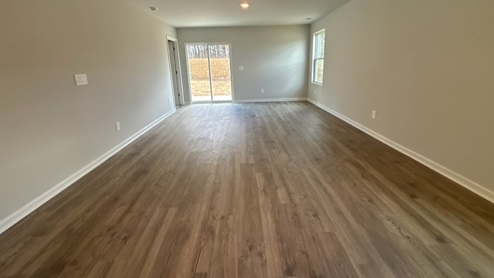 Living room in new, open-concept home with windows and natural lighting