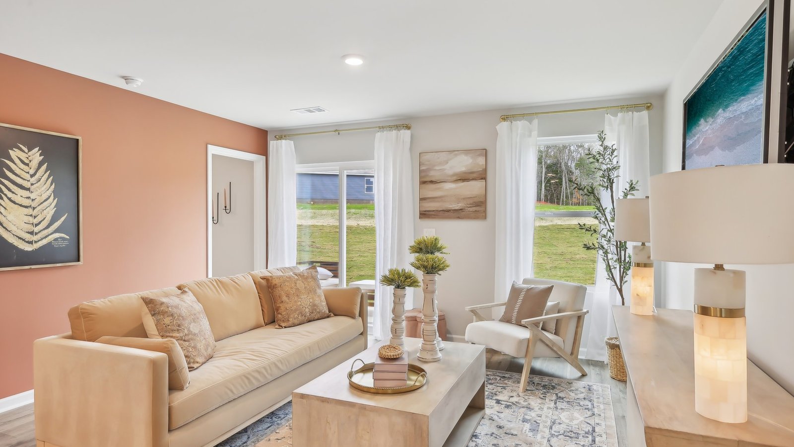 Living room in new, open-concept home with windows and natural lighting