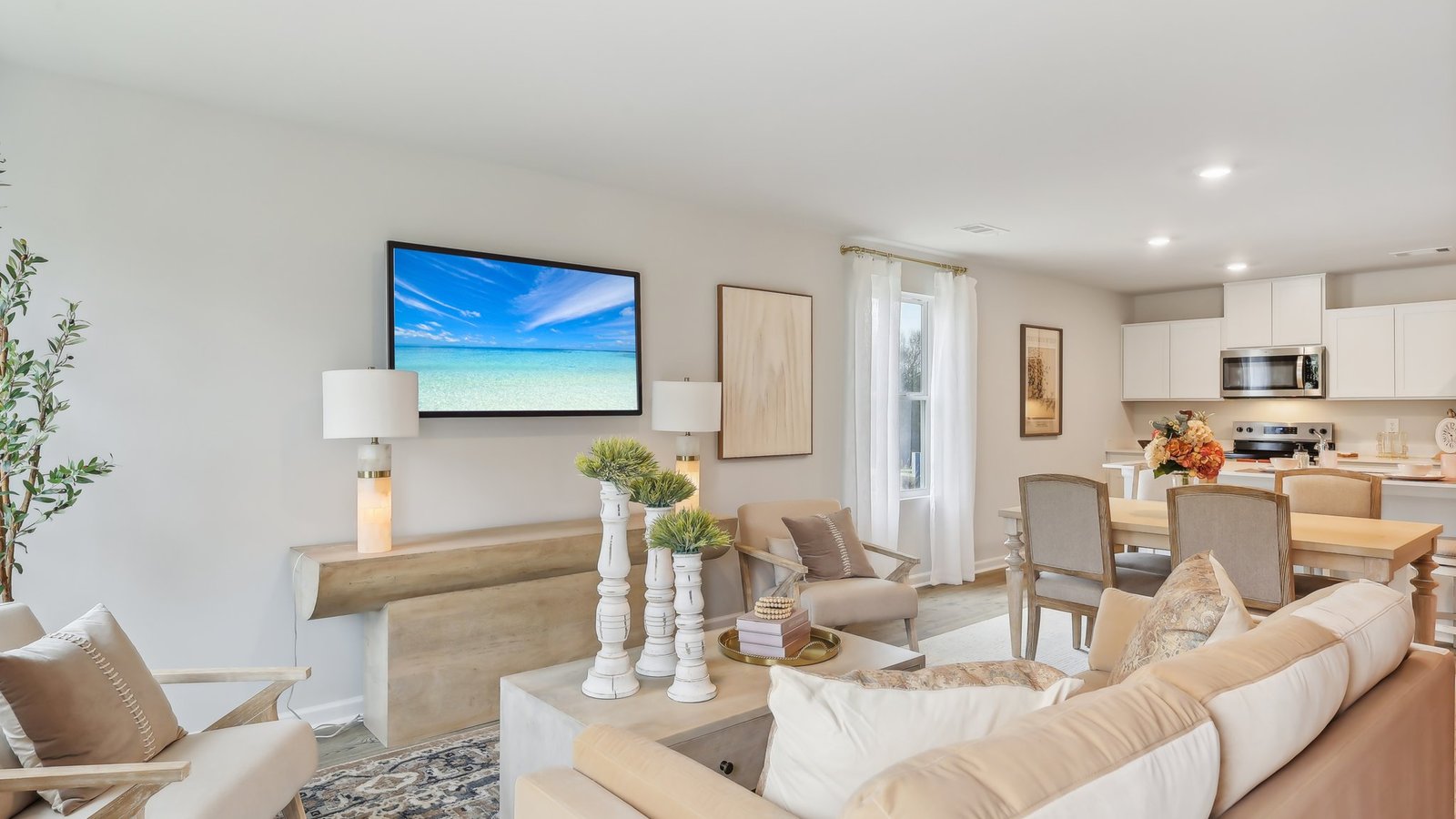 Living room in new, open-concept home with windows and natural lighting