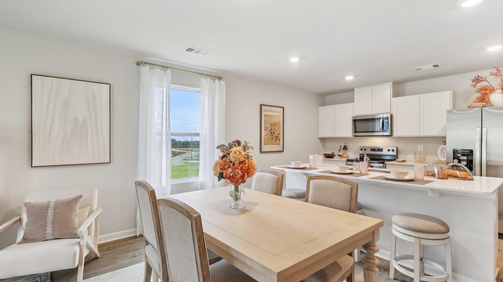 Dining room in new, open-concept home with windows and natural lighting