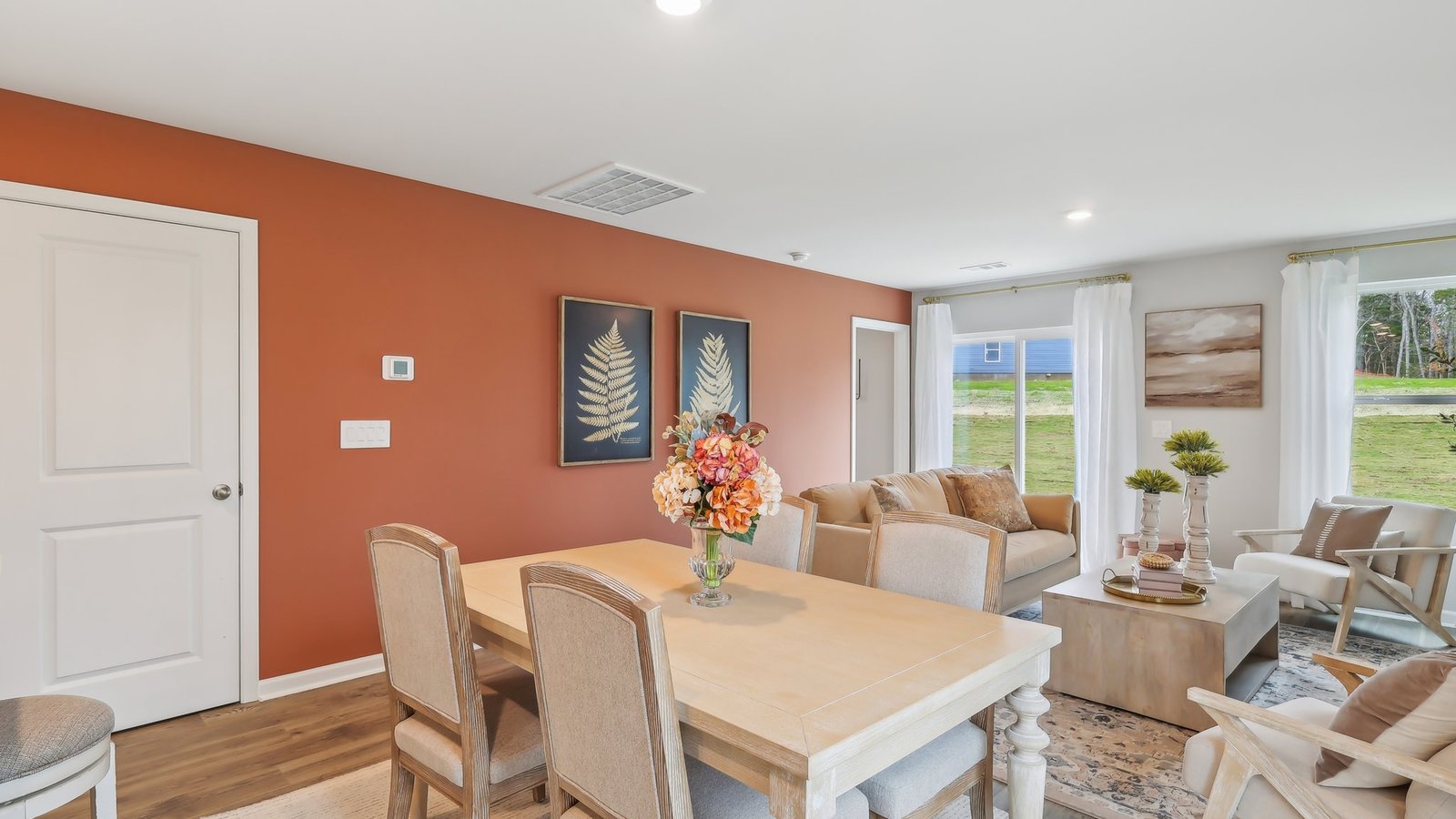 Dining room in new, open-concept home with windows and natural lighting