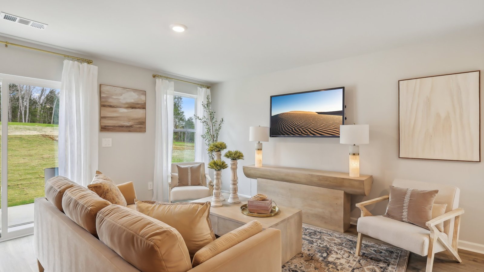 Living room in new, open-concept home with windows and natural lighting
