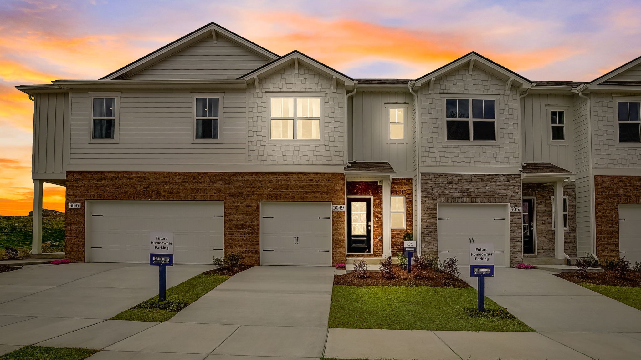 two story townhome exterior view at sunset