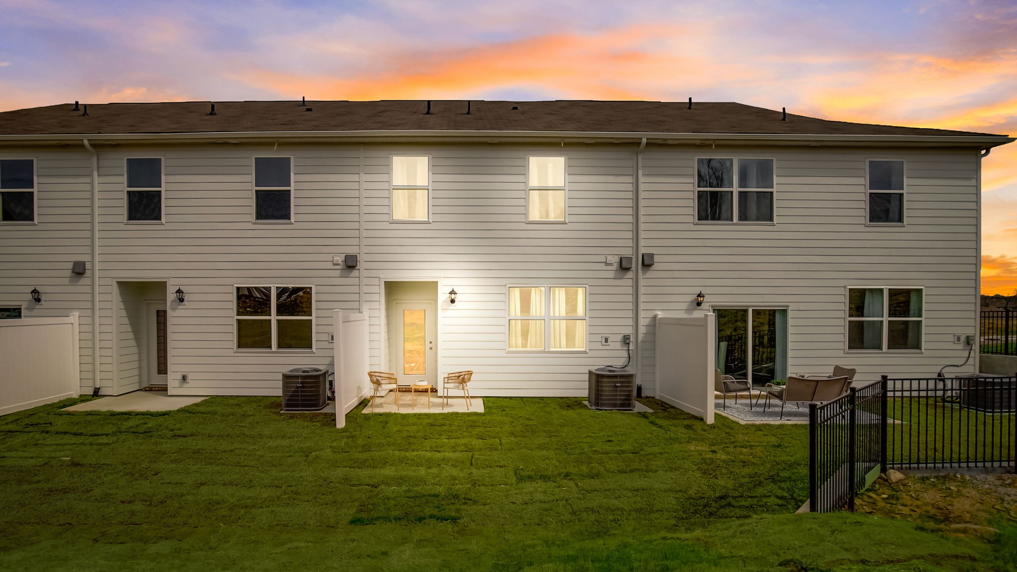 two story townhome exterior view of the back at sunset