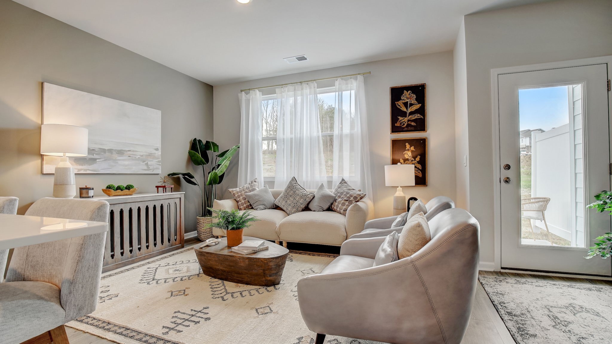 Open concept living and dining room in modern two story townhome.
