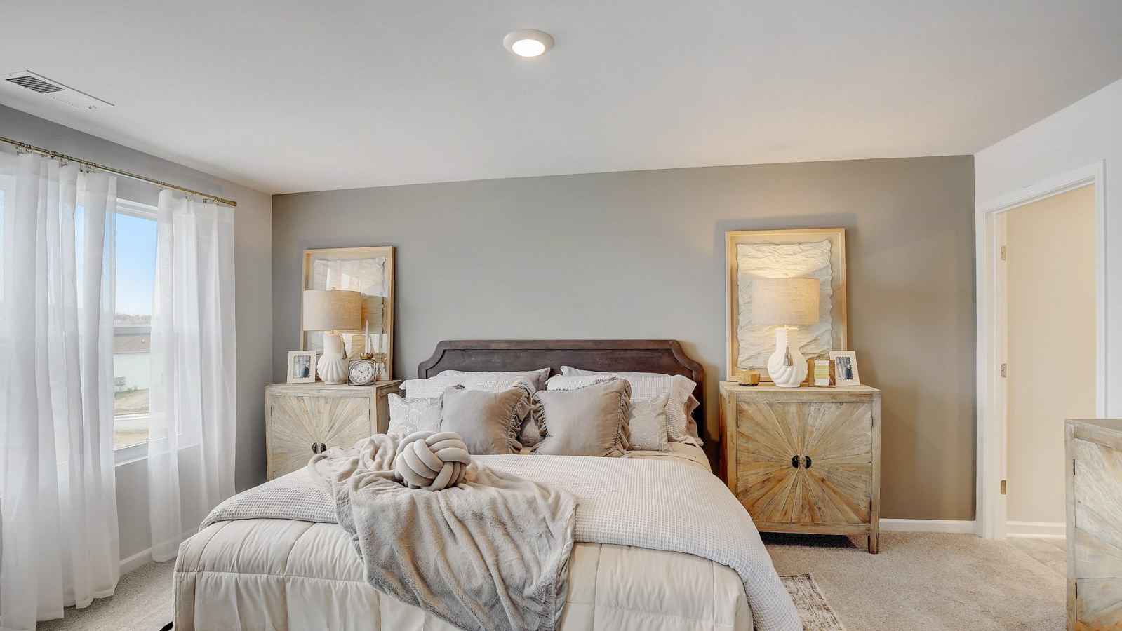 Bedroom with open view and windows in two story townhome