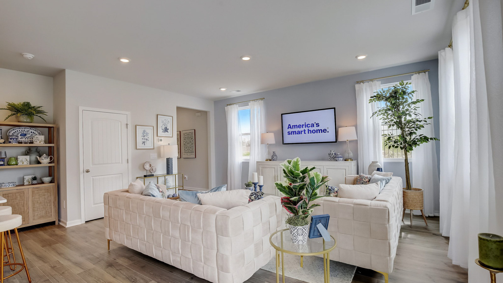 Living room in new, open-concept home with windows and natural lighting