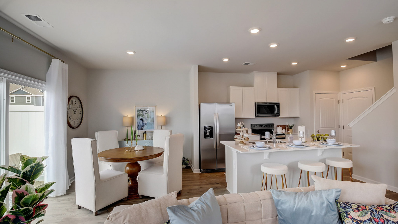 Dining room in new, open-concept home with windows and natural lighting