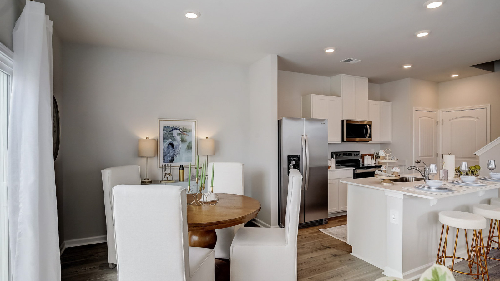 Dining table off of kitchen in two story townhome