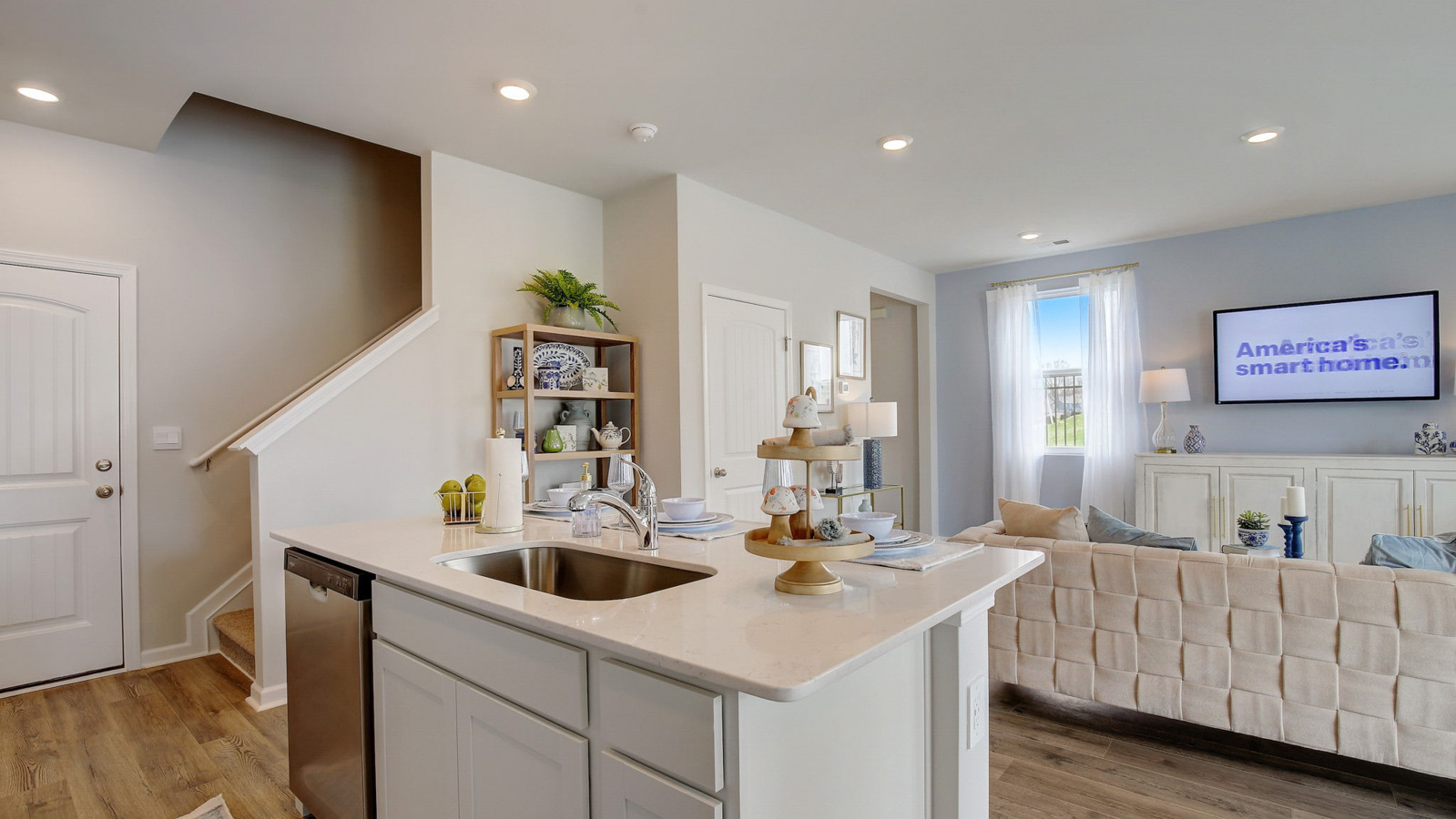 Kitchen peninsula with white cabinets and stainless steel appliances.