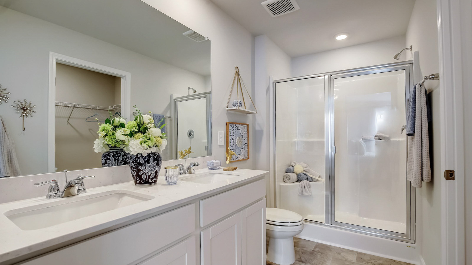 Primary bathroom with quartz countertops in two story townhome