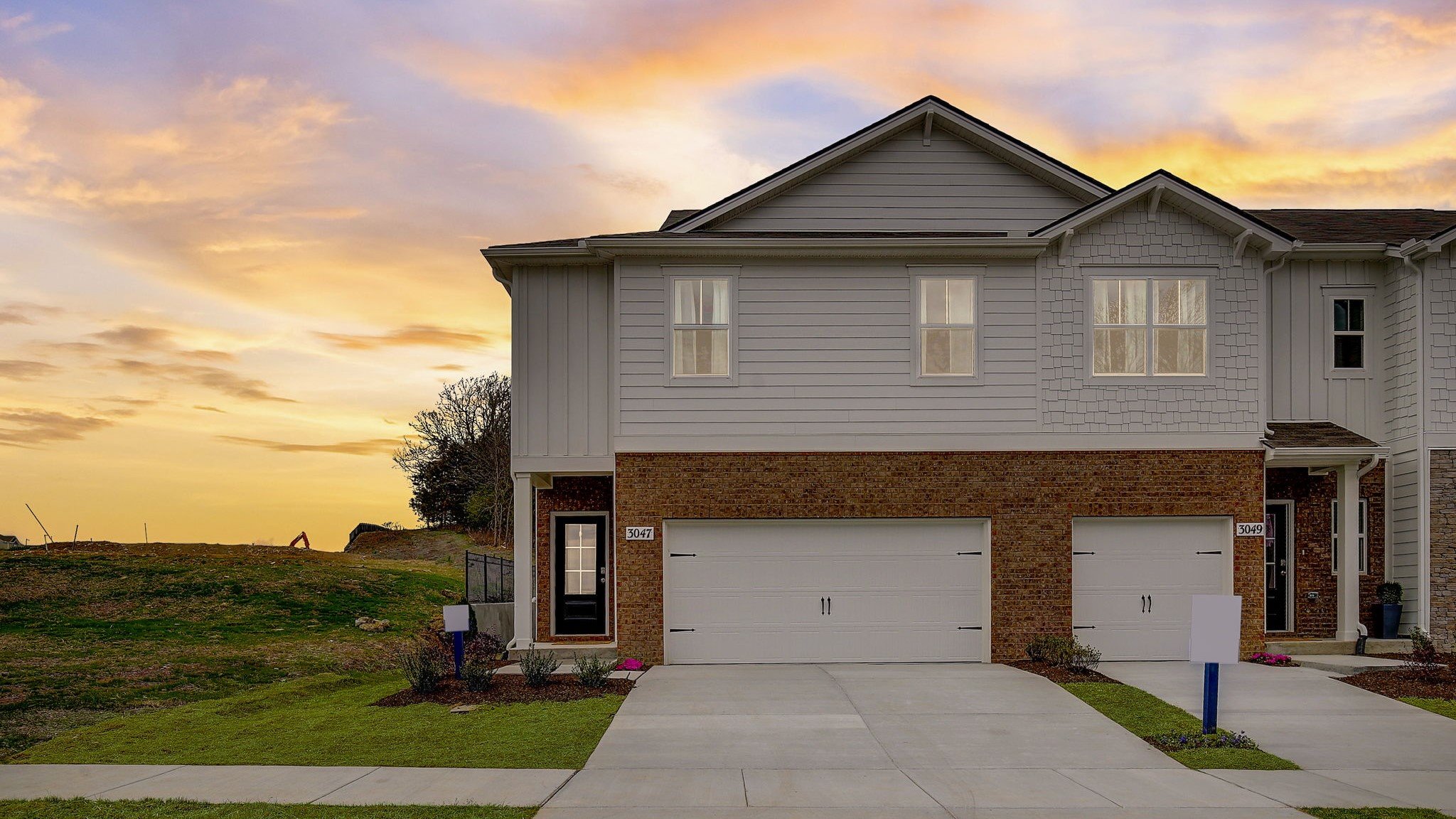 Exterior view at sunset of the portsmouth two story end unit townhome plan