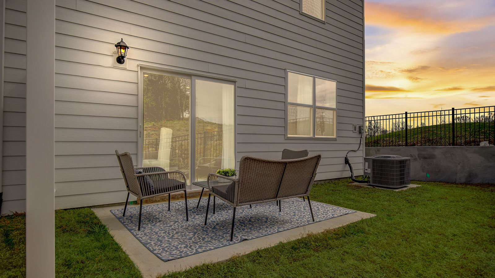 Exterior view at sunset of back porch of the portsmouth two story end unit townhome plan