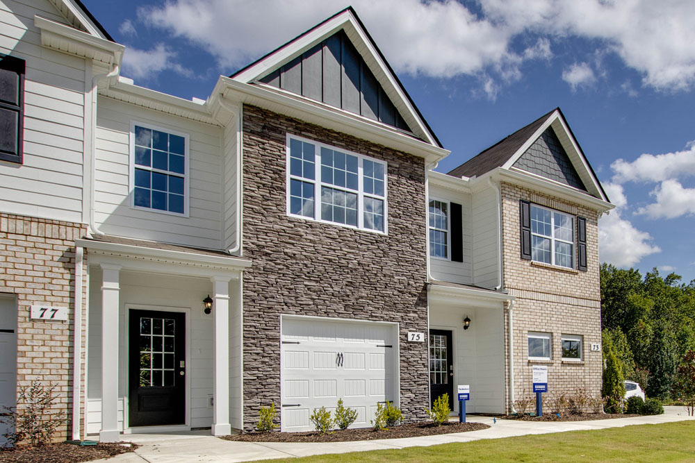 Medford townhome in paddington place exterior view of the front with brick and stone accents