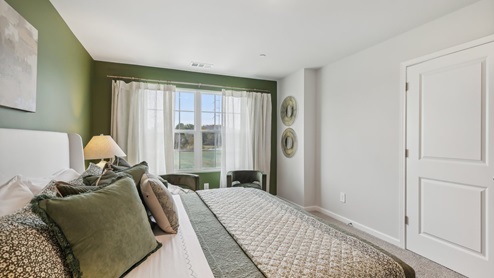 Primary bedroom with large windows
