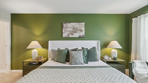 Primary bedroom with large windows