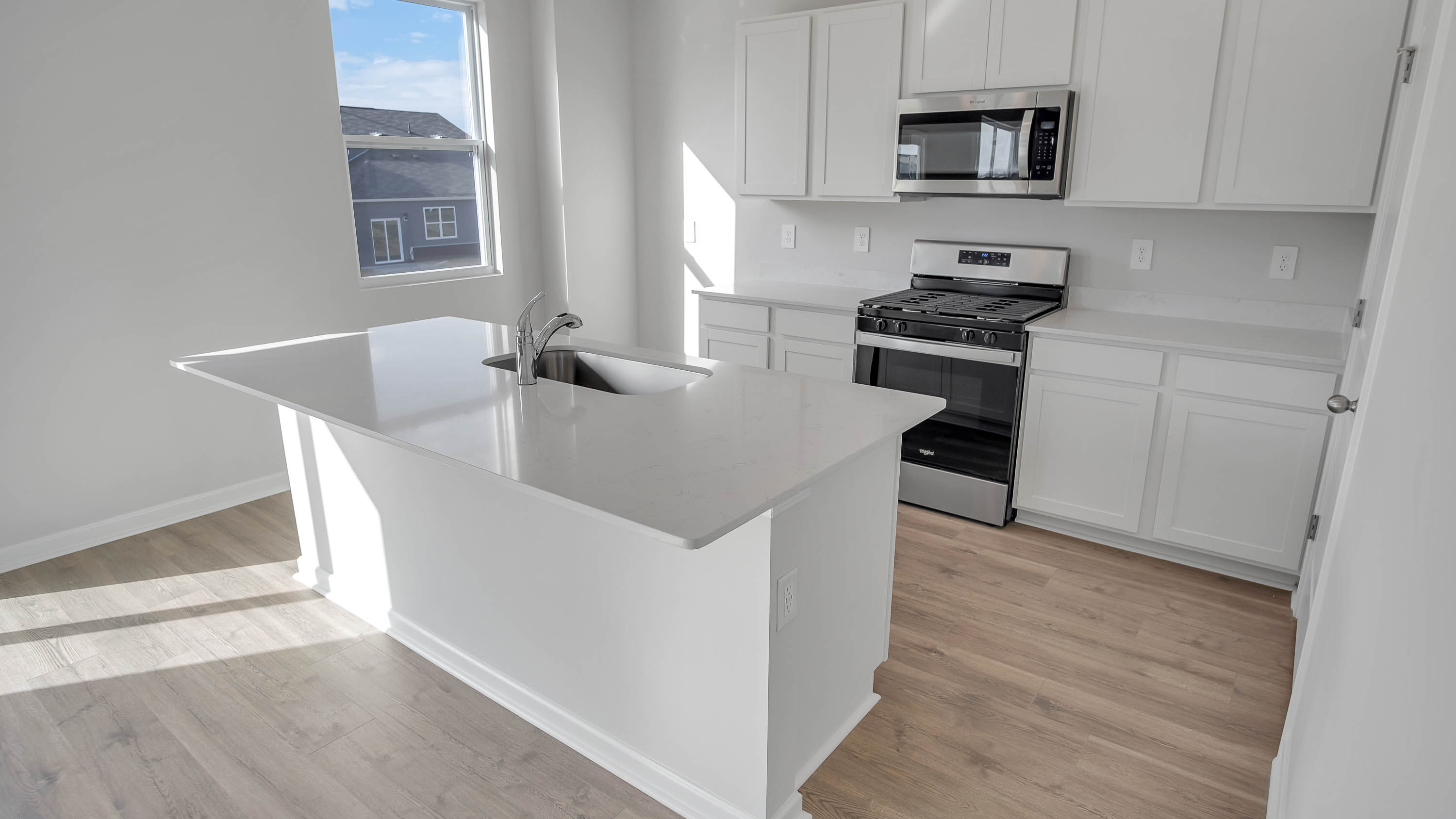 Modern kitchen with quartz countertops and stainless steel appliances