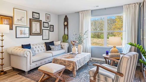 Living room in new, open-concept home with windows and natural lighting