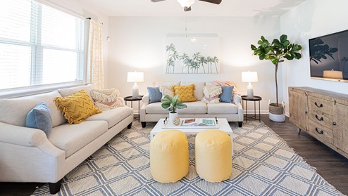 Living room in new, open-concept home with windows and natural lighting