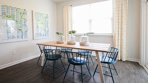 Dining room in new, open-concept home with windows and natural lighting