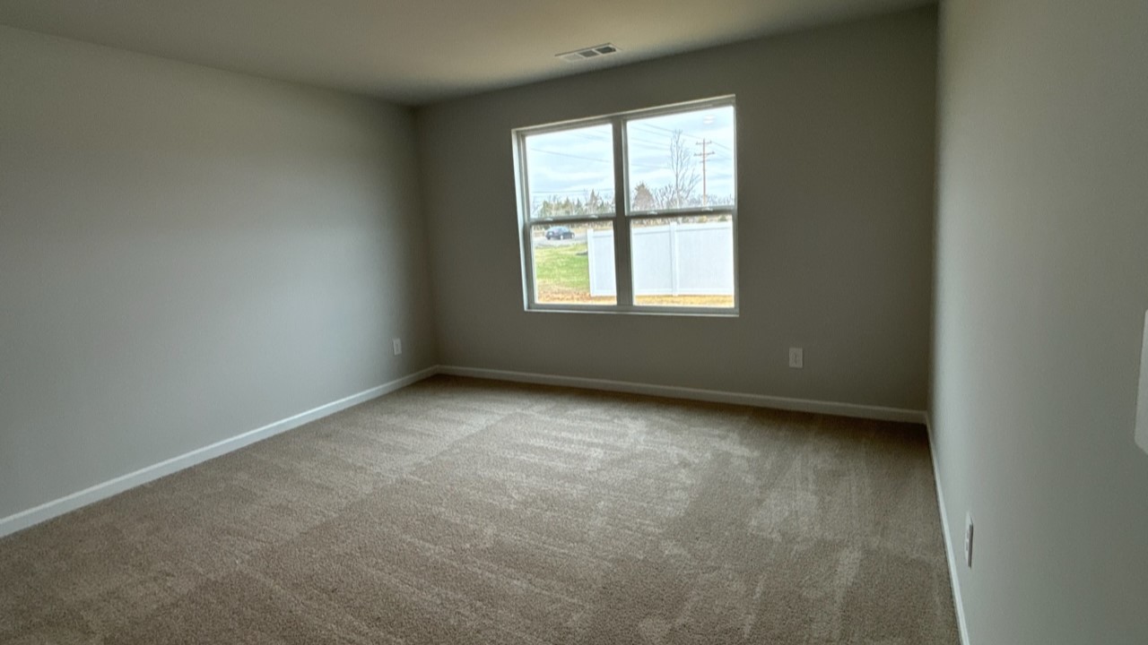 Bedroom in modern, open concept new home