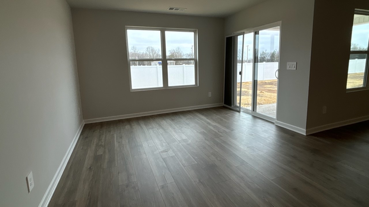 Dining room in new, open-concept home with windows and natural lighting
