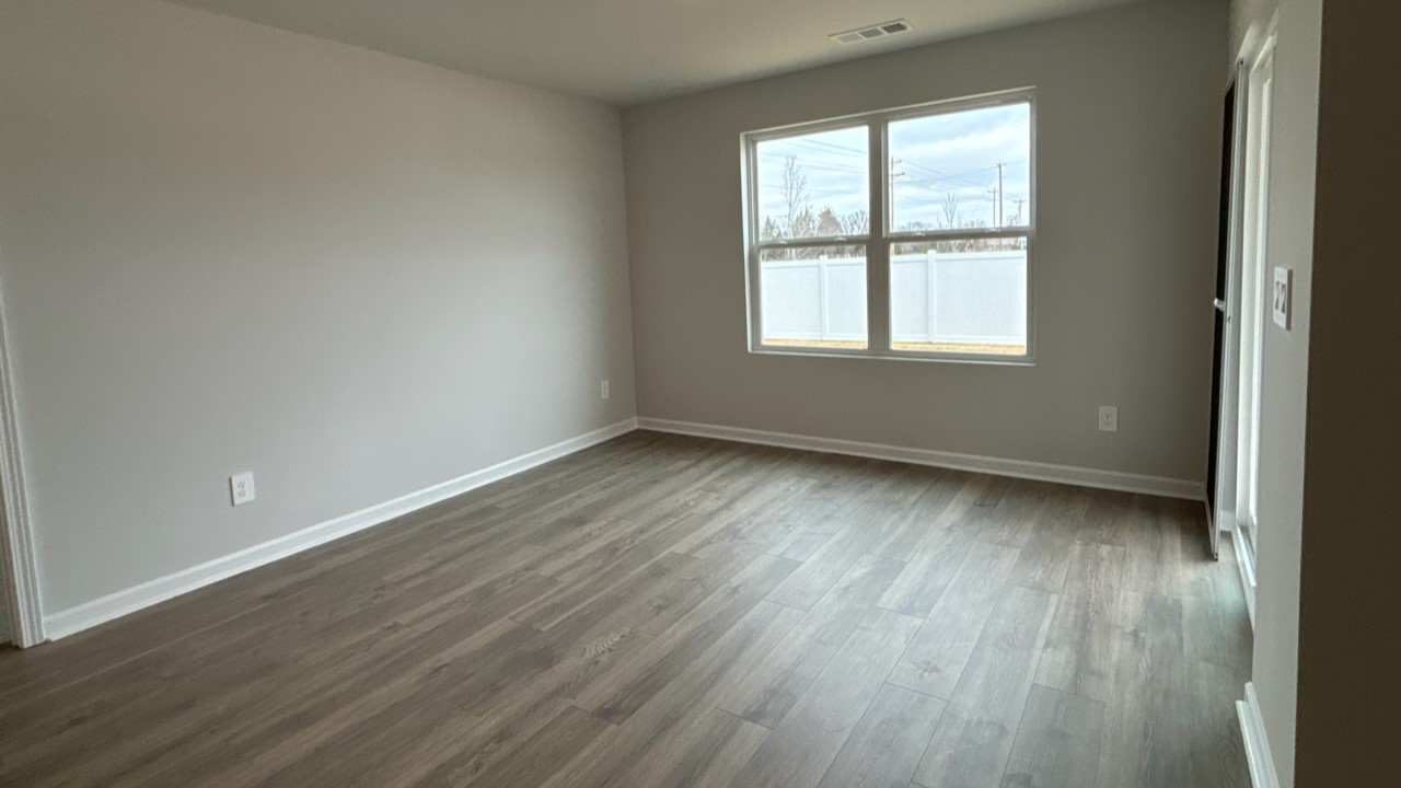 Dining room in new, open-concept home with windows and natural lighting