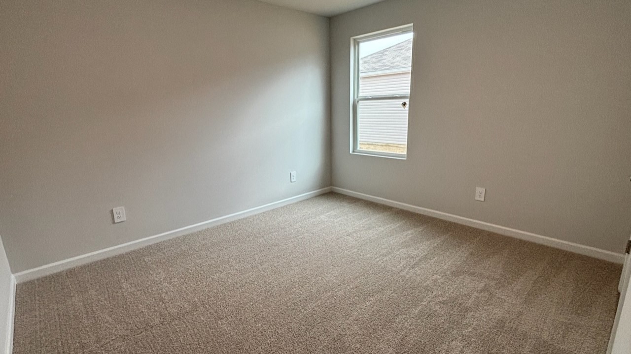 Bedroom in modern, open concept new home