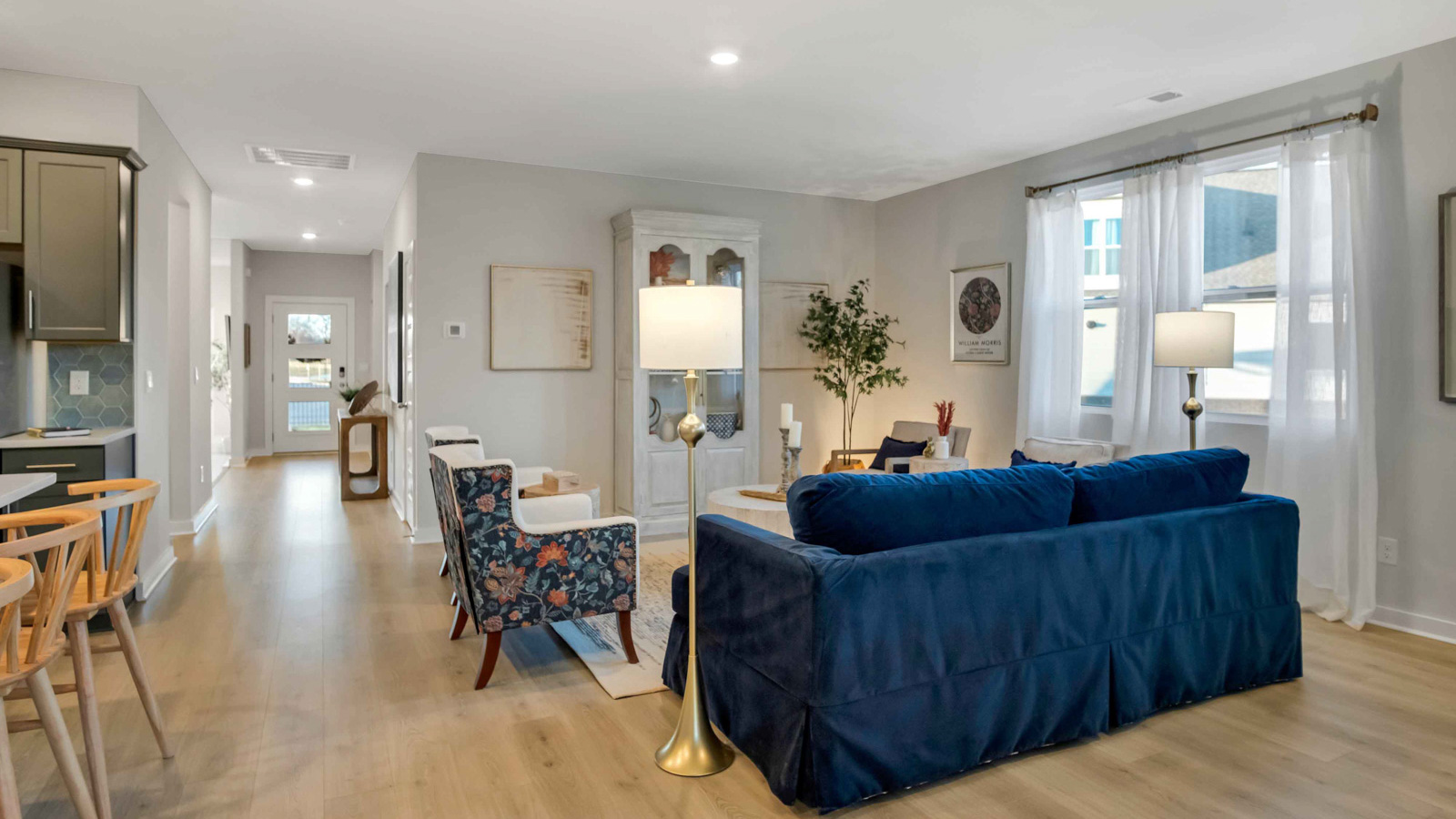 Living room in new, open-concept home with windows and natural lighting