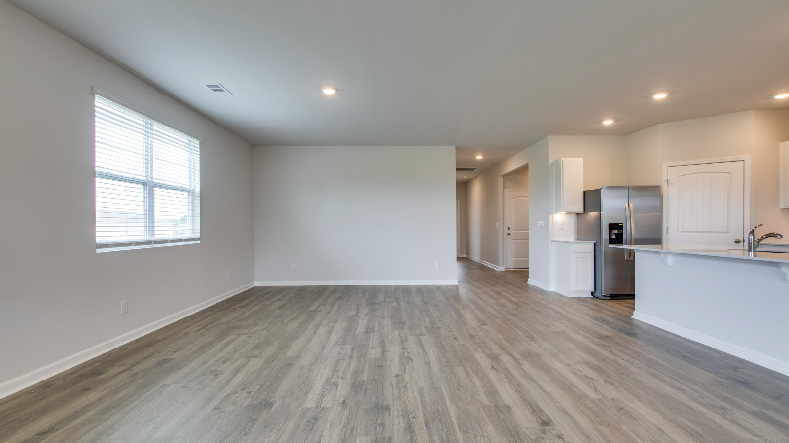Dining room in new, open-concept home with windows and natural lighting