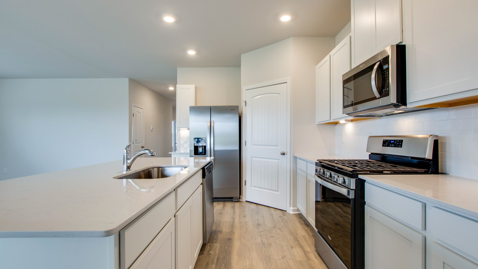 Modern kitchen with quartz countertops and stainless steel appliances