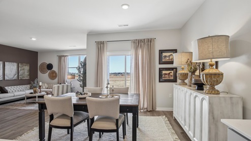 Dining room in new, open-concept home with windows and natural lighting