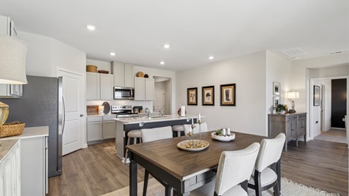 Dining room in new, open-concept home with windows and natural lighting